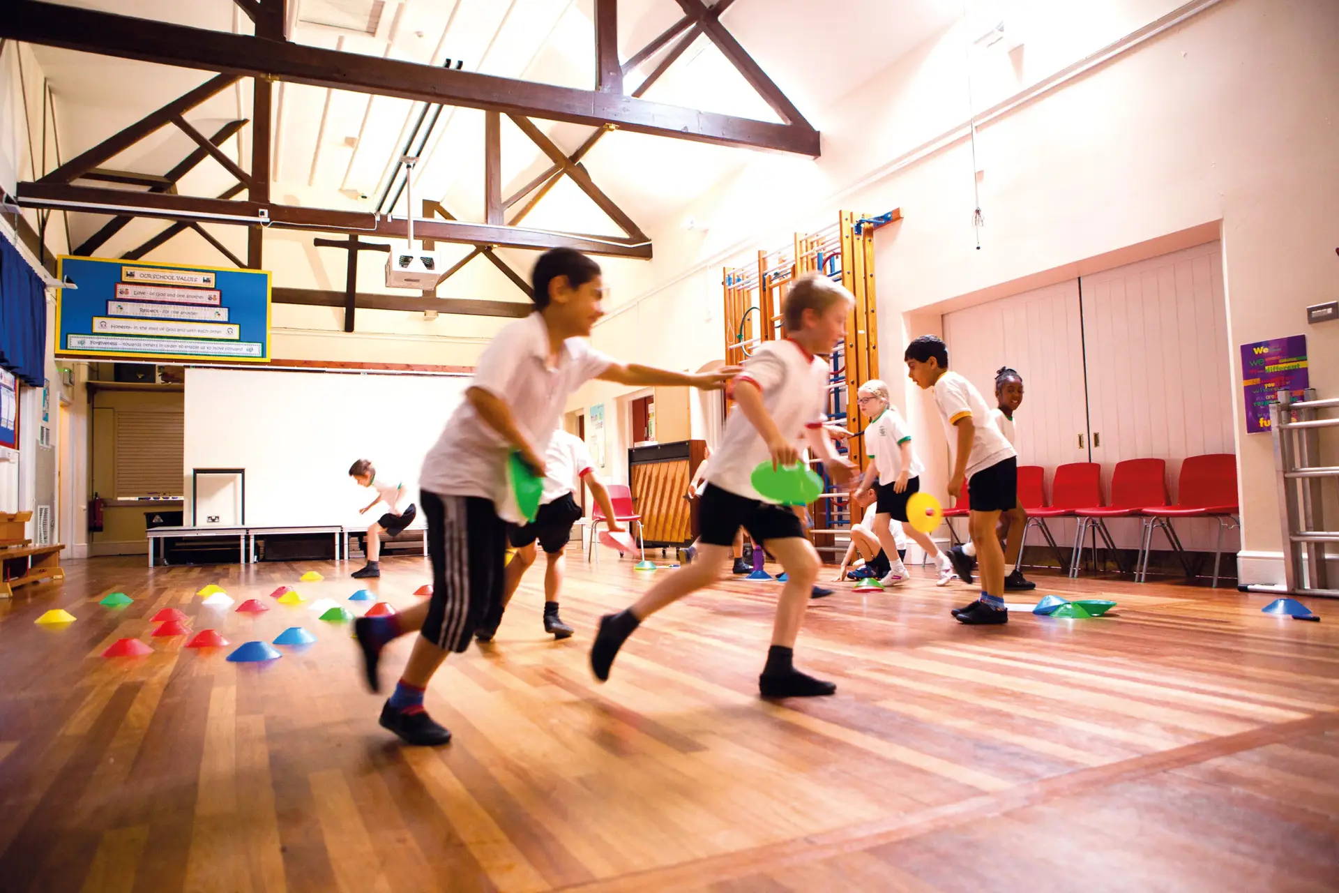 Children playing in a school hall gym