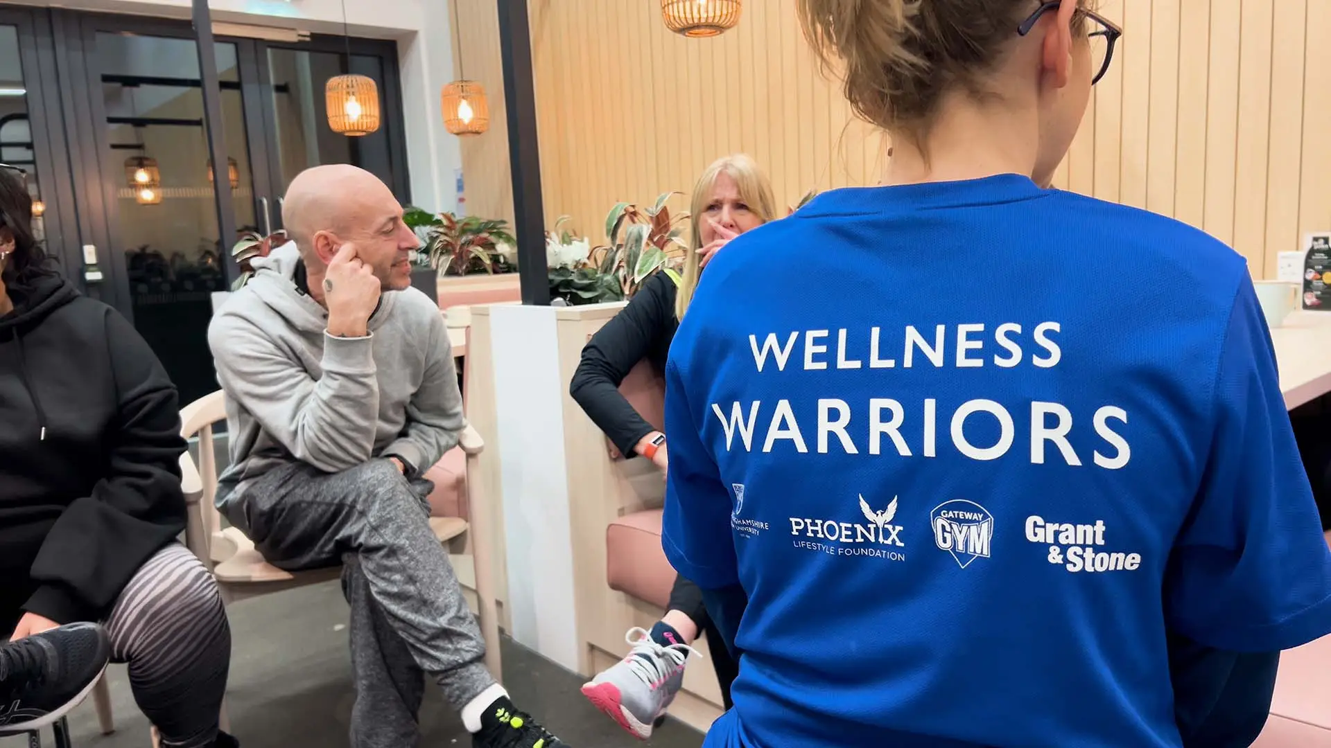 Wellmess Warrior team talking in a group