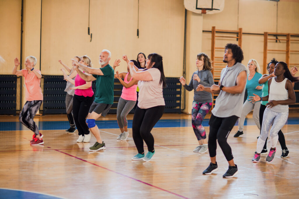 Group of people doing keep fit in a sports hall