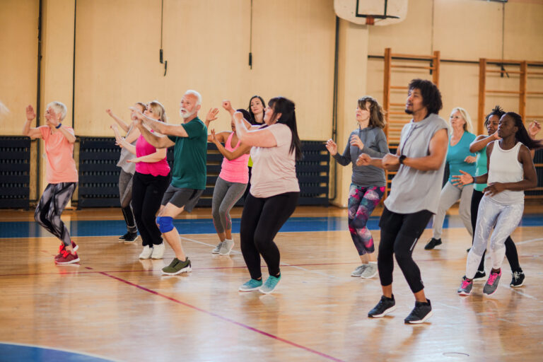 Group of people doing keep fit in a sports hall