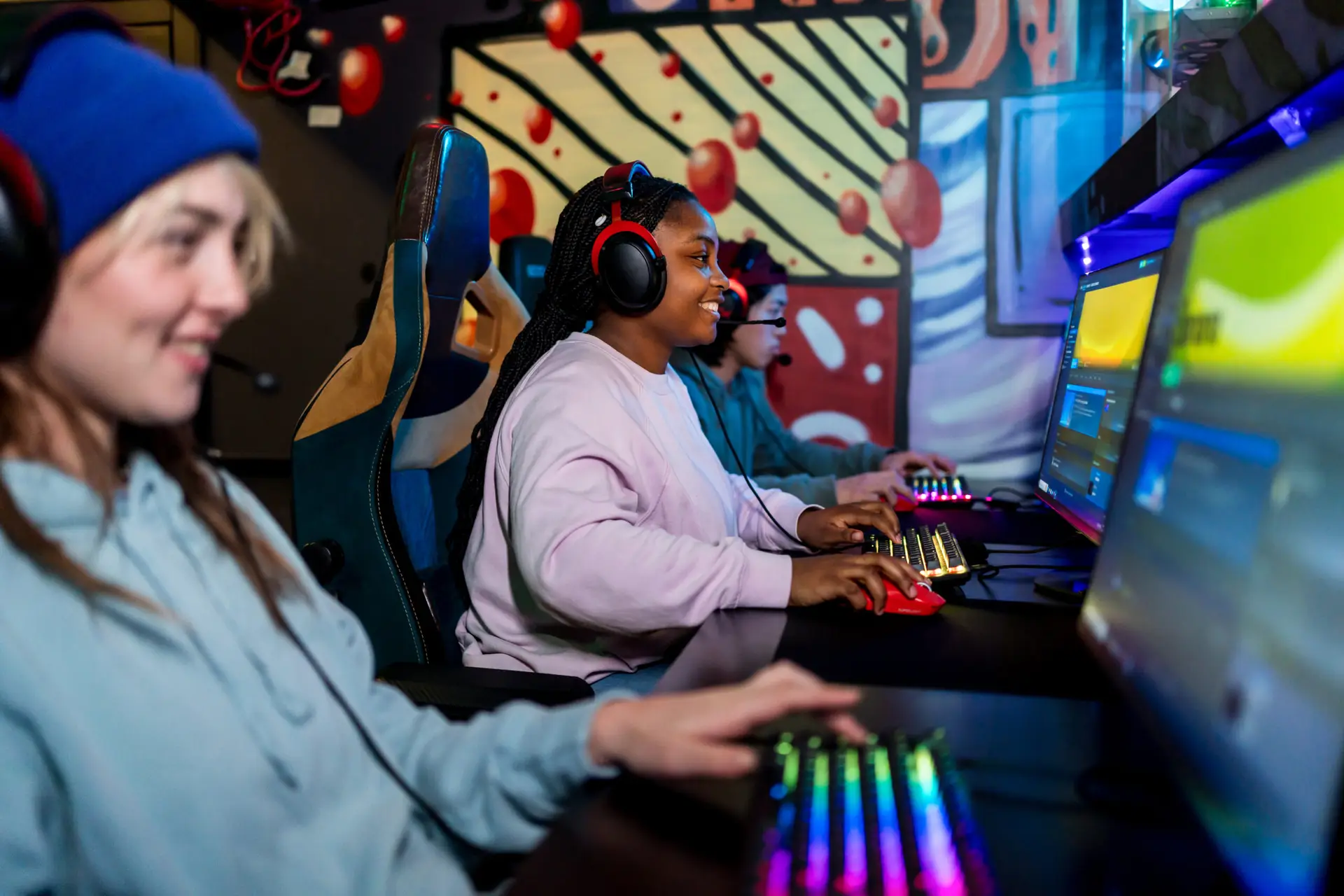 Young female gamer playing video game on a desktop computer at a competition